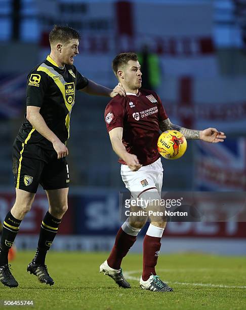 James Collins of Northampton Town attempts to control the ball under pressure from Adam Dugdale of Morecambe during the Sky Bet League Two match...