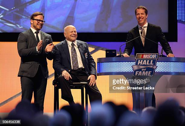 Marcus Smith and his father, Bruton Smith, watch as NASCAR Sprint Cup Series driver, Brad Keselowski, speaks during the NASCAR Hall of Fame Induction...
