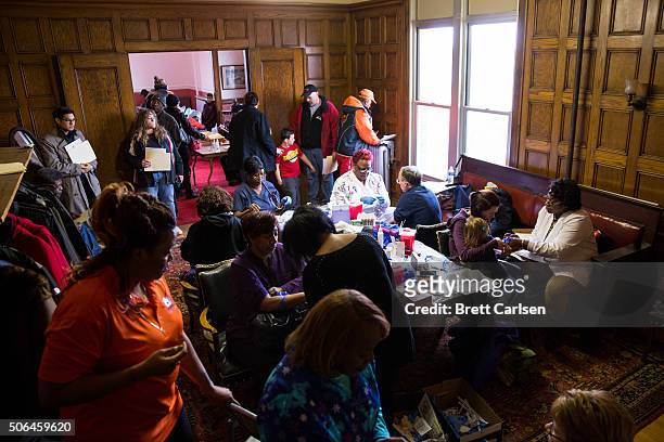 Nurses and citizens gather in an upstairs meeting room where blood is being drawn for lead poisoning testing at the Masonic Temple on January 23,...