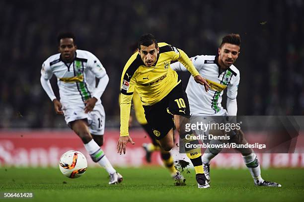 Henrikh Mkhitaryan of Borussia Dortmund vies for the ball chased by Julian Korb and Ibrahima Traore of Borussia Moenchengladbach during the...