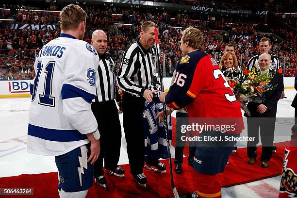 Linesmen Pierre Racicot is officiating his 1500th game tonight between the Florida Panthers and the Tampa Bay Lightning. He is given a signed stick...