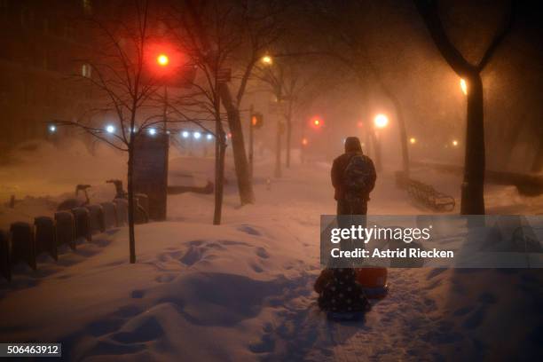 Children are pulled home after playing at Riverside Park which was covered in snow after a day of constant snow fall on January 23, 2016 in New York...