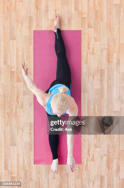 luftaufnahme von einer frau tun yoga - spagat frau stock-fotos und bilder