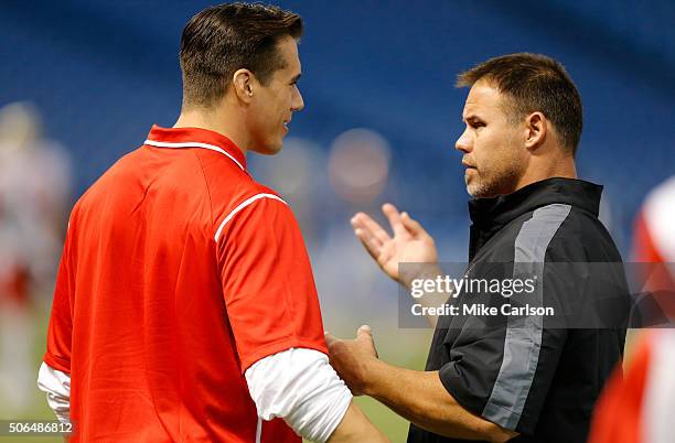 Coaches Brady Quinn, left, and Mike Alstott of the East Team talk during the first half of the East West Shrine Game at Tropicana Field on January...