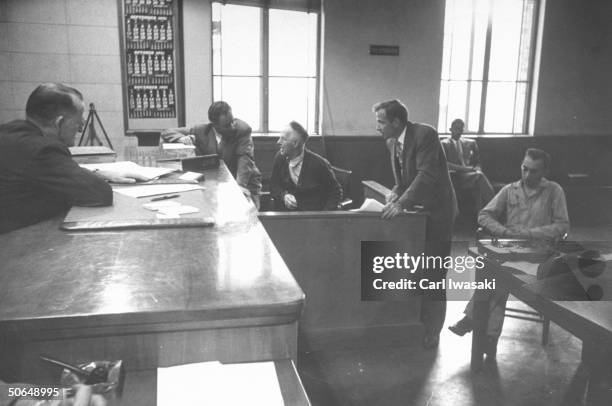 Denver University law students Harry Anderson and Donald Gallion examining Joseph Makosky on the witness stand during the trial.