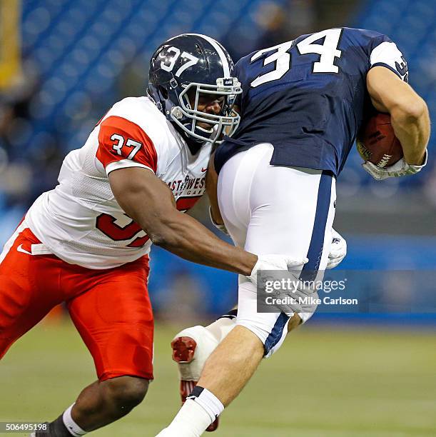 Antwione Willams from Georgia Southern playing on the East Team tackles Derek Watt from Wisconsin playing on the West Team during the second half of...