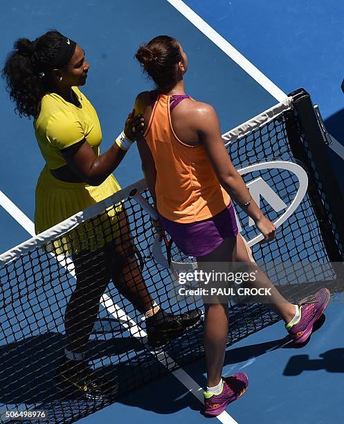 Serena Williams of the US pats Russia's Margarita Gasparyan following her win during their women's singles game on day seven of the 2015 Australian...