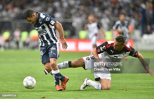 Walter Gargano of Monterrey covers the ball from the mark of Gonzalo Bergessio of Atlas during the 3rd round match between Monterrey and Atlas as...