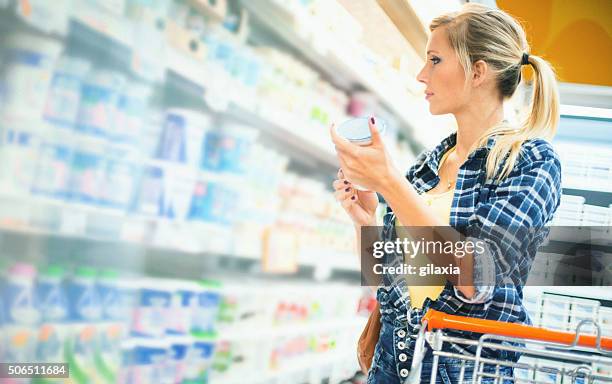 woman buying food in supermarket. - convenience stock pictures, royalty-free photos & images
