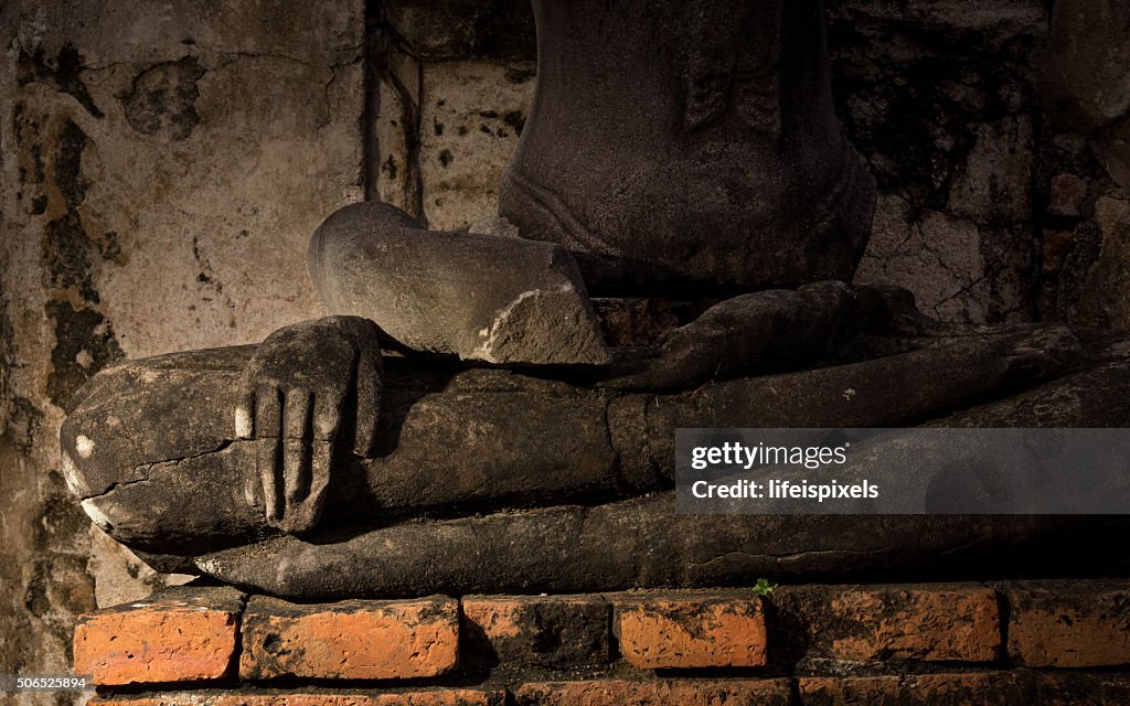 A broken image of Buddha in meditation posture