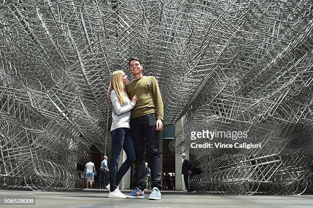 Milos Raonic of Canada poses with girlfriend Danielle Knudson in front of Ai Weiwei Forever Bicycles exhibition at The National Gallery Victoria...