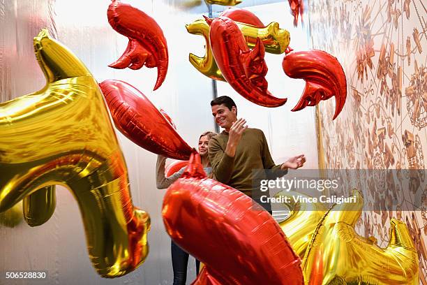 Milos Raonic of Canada poses with girlfriend Danielle Knudson in front of Ai Weiwei Bird Balloon exhibition at The National Gallery Victoria during...