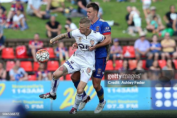 Andrew Keogh of the Mariners is contested by Daniel Mullen of the Jets during the round 16 A-League match between the Newcastle Jets and the Perth...