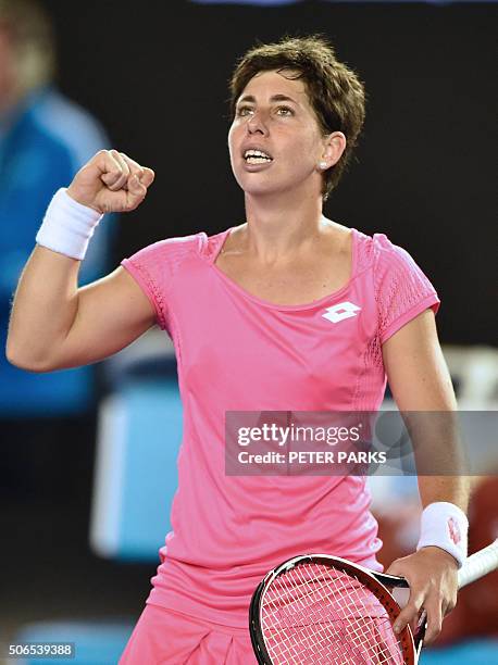 Spain's Carla Suarez Navarro gestures after victory in her women's singles match against Australia's Daria Gavrilova on day seven of the 2016...