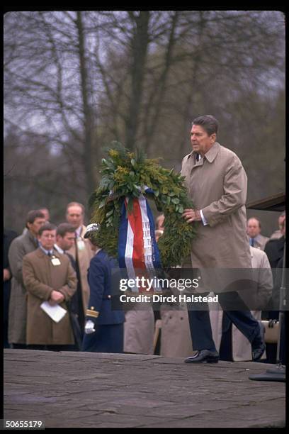 President Ronald Reagan laying wreath at Bergen-Belsen concentration camp memorial.