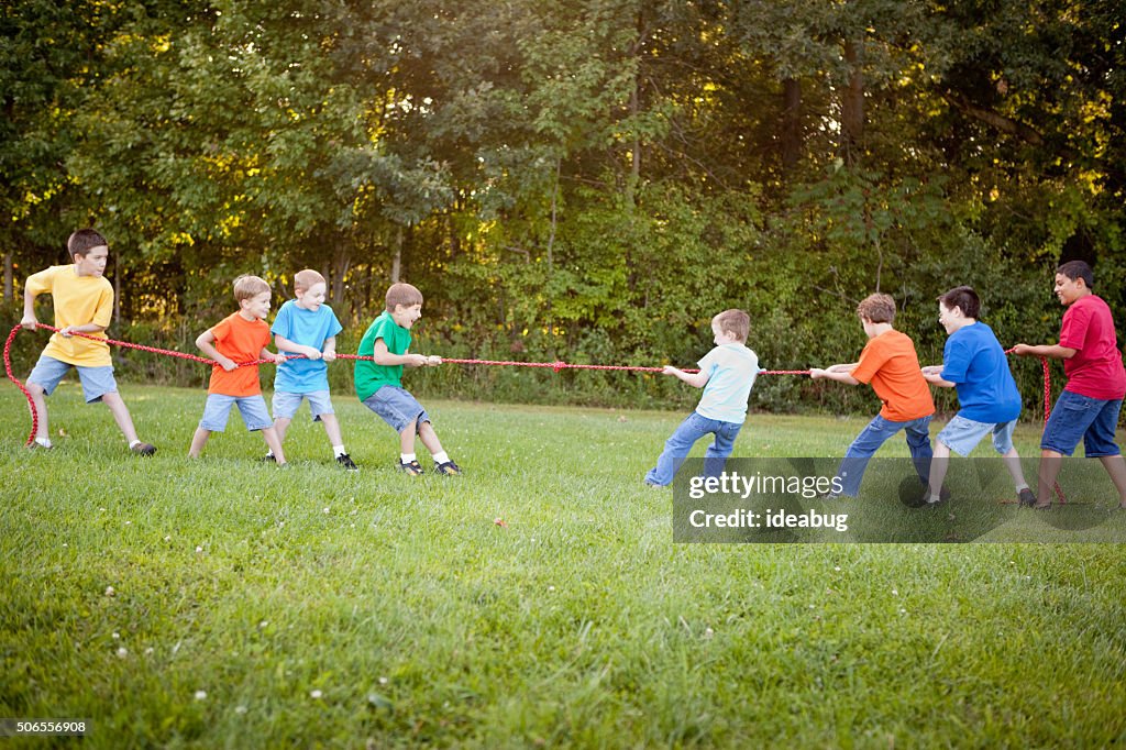 Group of Boys Playing Tug of War Outside