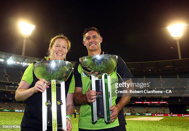 Alex Blackwell of the Sydney Thunder women's team and Mike Hussey of the Sydney Thunder pose with the winners trophies after the Big Bash League...