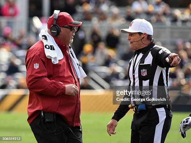 Head coach Bruce Arians of the Arizona Cardinals talks to referee Ed Hochuli during a game against the Pittsburgh Steelers at Heinz Field on October...