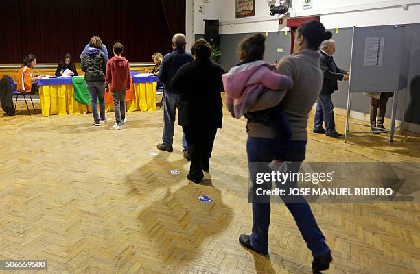 People queue to cast their ballots at a pool station in Fontanelas in the municipality of Sintra, on the outskirts of Lisbon on January 24 during the...