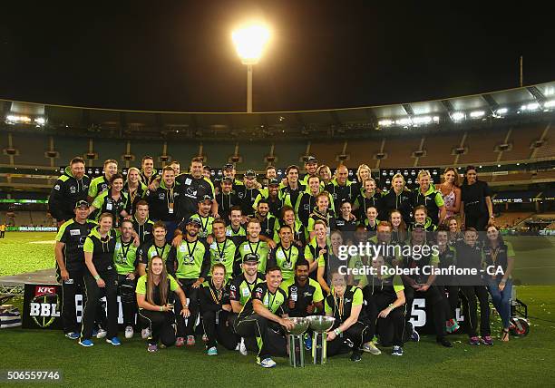 The Sydney Thunder men's and women's team pose after winning their respective finals in the Big Bash League final match between Melbourne Stars and...