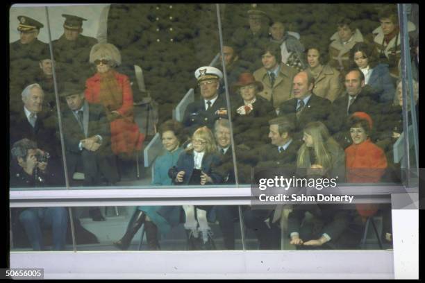 Newly elected US President Jimmy Carter and Vice President Walter Mondale sitting with their familes in the reviewing stands for Inaugural Parade.