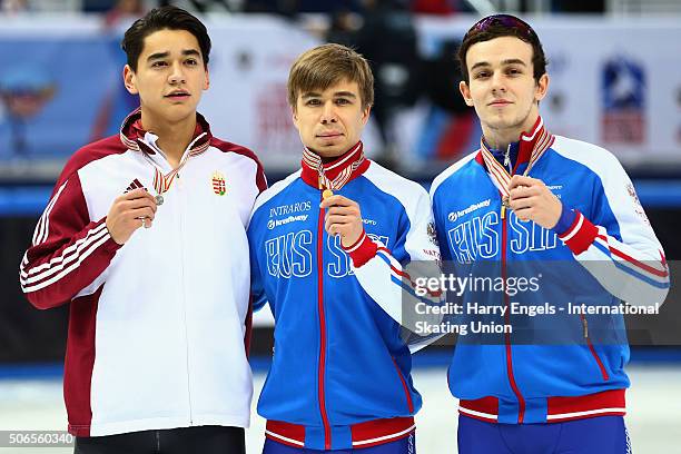 Second place Shaolin Sandor Liu of Hungary, winner Semen Elistratov of Russia and third place Dmitry Migunov of Russia pose with their medals...