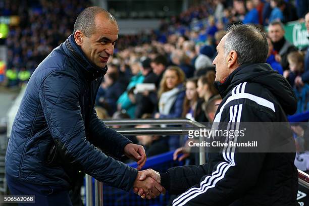 Francesco Guidolin, Manager of Swansea City shakes hands with Roberto Martinez, Manager of Everton before the Barclays Premier League match between...