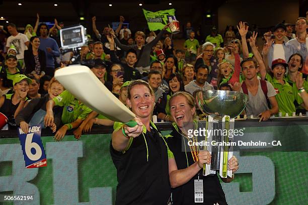 Claire Koski and Alex Blackwell of the Thunder take a selfie with the tropy following the Big Bash League final match between Melbourne Stars and the...