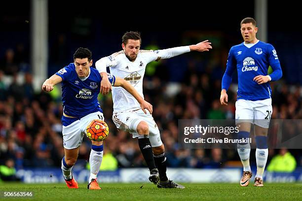 Gareth Barry of Everton battles for the ball with Gylfi Sigurdsson of Swansea City during the Barclays Premier League match between Everton and...