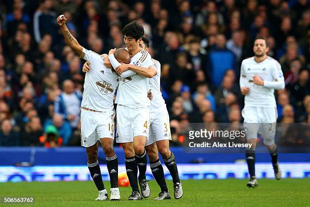 Andre Ayew of Swansea City celebrates with team-mates after scoring his team's second goal during the Barclays Premier League match between Everton...