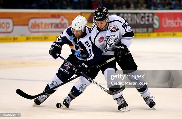Brett Festerling of Hamburg Freezers battles for the puck with David Steckel of Thomas Sabo Ice Tigers during the DEL game between Hamburg Freezers...