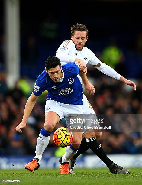 Gareth Barry of Everton battles for the ball with Gylfi Sigurdsson of Swansea City during the Barclays Premier League match between Everton and...