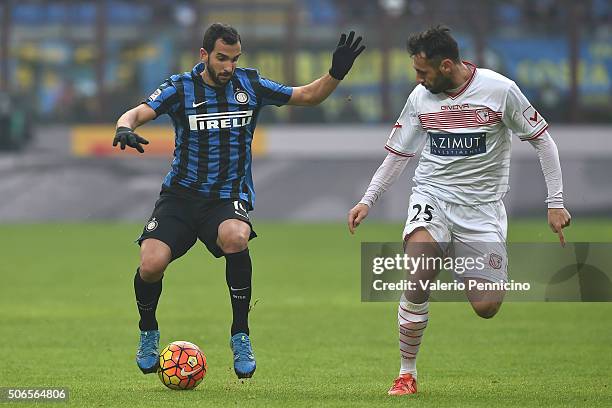 Martin Montoya of FC Internazionale Milano in action against Matteo Mancosu of Carpi FC during the Serie A match between FC Internazionale Milano and...