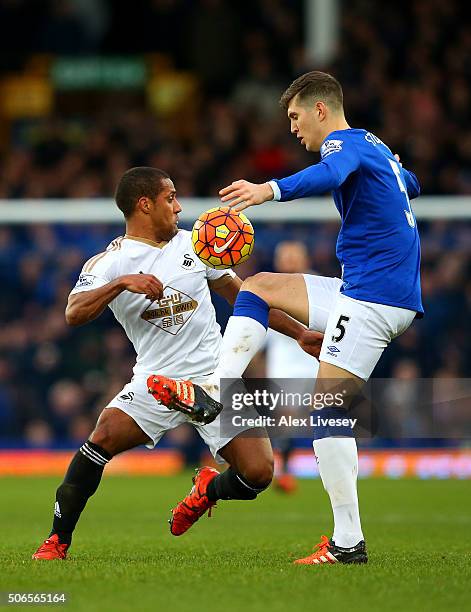 John Stones of Everton battles for the ball with Wayne Routledge of Swansea City during the Barclays Premier League match between Everton and Swansea...