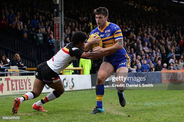 Tom Briscoe of Leeds Rhinos breaks through a tackle from Oscar Thomas of Bradford Bulls to cross over to score his side a try during the Leeds Rhinos...