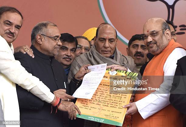 Home Minister Rajnath Singh and other party leaders greet to BJP leader Amit Shah after he was re-elected as Party President at BJP HQ on January 24,...