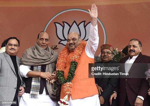 Home Minister Rajnath Singh and other party leaders greet to BJP leader Amit Shah after he was re-elected as Party President at BJP HQ on January 24,...