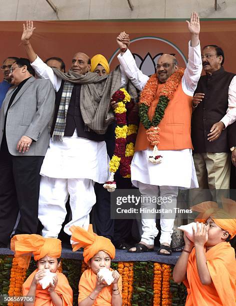 Home Minister Rajnath Singh and other party leaders greet to BJP leader Amit Shah after he was re-elected as Party President at BJP HQ on January 24,...