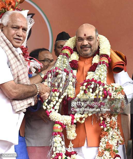 Yeddyurappa greets to BJP leader Amit Shah after he was re-elected as Party President at BJP HQ on January 24, 2016 in New Delhi, India. Shah was...