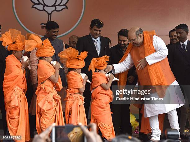 Children greet to BJP leader Amit Shah after he was re-elected as Party President at BJP HQ on January 24, 2016 in New Delhi, India. Shah was elected...