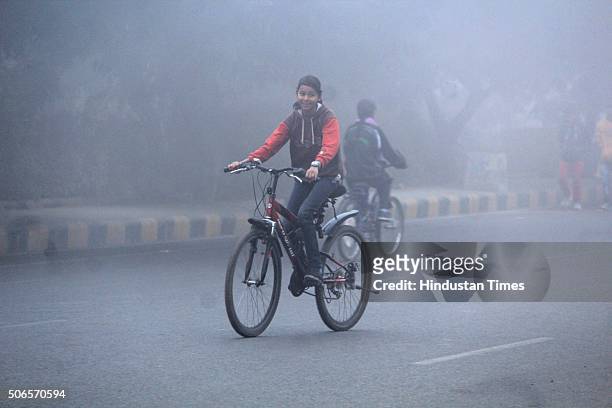 People participate on the Raahgiri Day during a cold wave and foggy weather, on January 24, 2016 in Gurgaon, India. The fog has disrupted road...