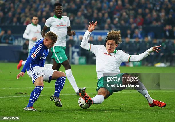 Jannik Vestergaard of Werder Bremen slides to tackle Max Meyer of Schalke during the Bundesliga match between FC Schalke 04 and Werder Bremen at...