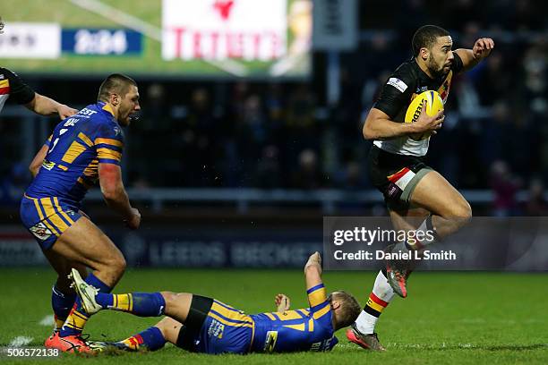 Omari Caro of Bradford Bulls passes through a tackle from Rob Burrow of Leeds Rhinos during the Leeds Rhinos v Bradford Bulls friendly match at...