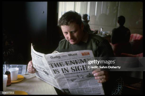 Soldier reading DAILY MAIL w. Headline THE ENEMY IS IN SIGHT, during lunch aboard QE2 before setting sail to Falklands