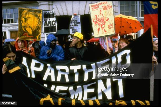 Anti-Apartheid demonstrators holding vigil for commonwealth decision in favor of economic sanctions toward South Africa, w. Poster of iconic prisoner...