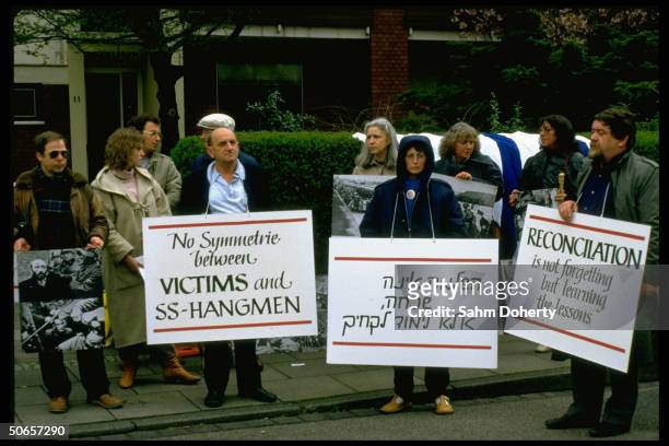Demonstrators w. Signs at Jewish protest in remembrance of Holocaust, against Pres. Ronald Reagan's visit to Bitburg cemetery outside CDU HQ