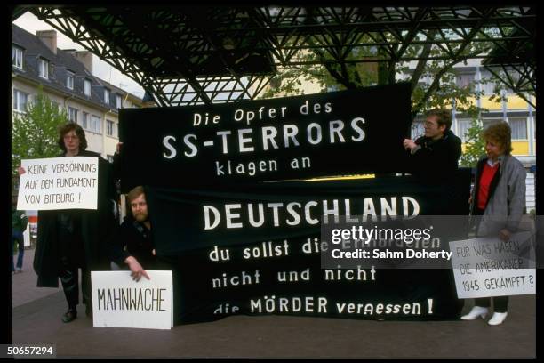 Demonstrators w. Signs at Jewish protest in remembrance of Holocaust, against Pres. Ronald Reagan's visit to Bitburg cemetery outside CDU HQ