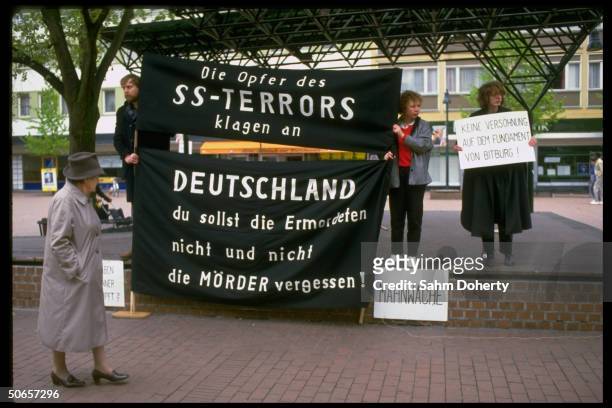 Demonstrators w. Signs at Jewish protest in remembrance of Holocaust, against Pres. Ronald Reagan's visit to Bitburg cemetery outside CDU HQ