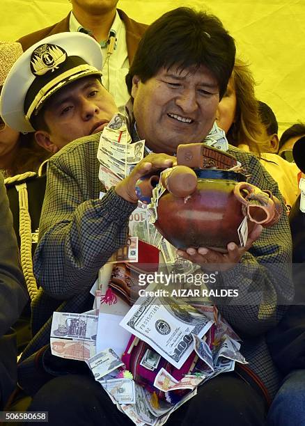 Bolivian President Evo Morales receives a gift at the start of the Alasitas festival on January 24 , 2016 in La Paz. The month-long annual cultural...