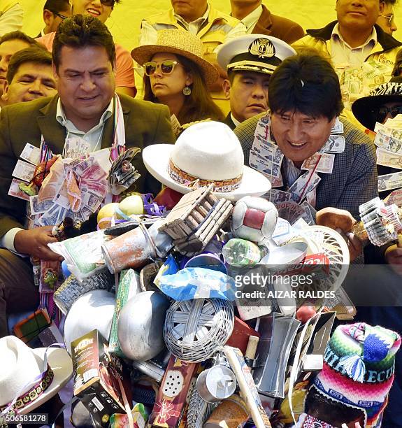 Bolivian President Evo Morales and La Paz Mayor Luis Revilla pay homage to Ekeko, the Aymara god of abundance, at the start of the month-long...